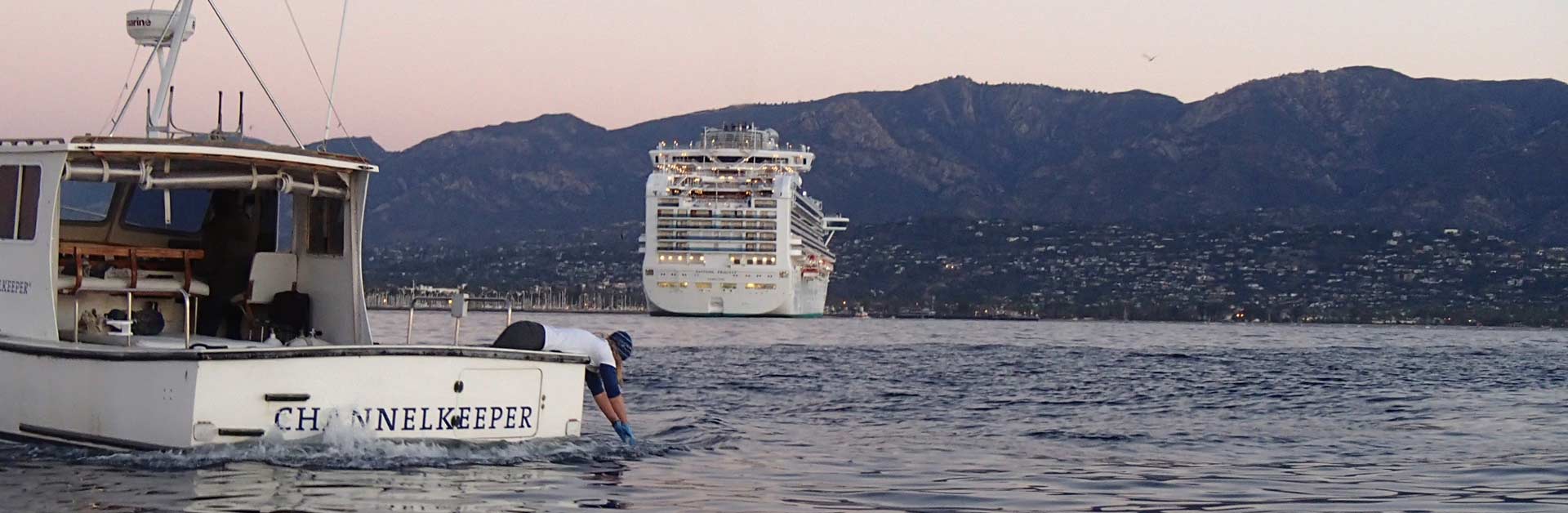 Santa Barbara Channelkeeper's team testing the water for pollution behind a huge cruise ship.