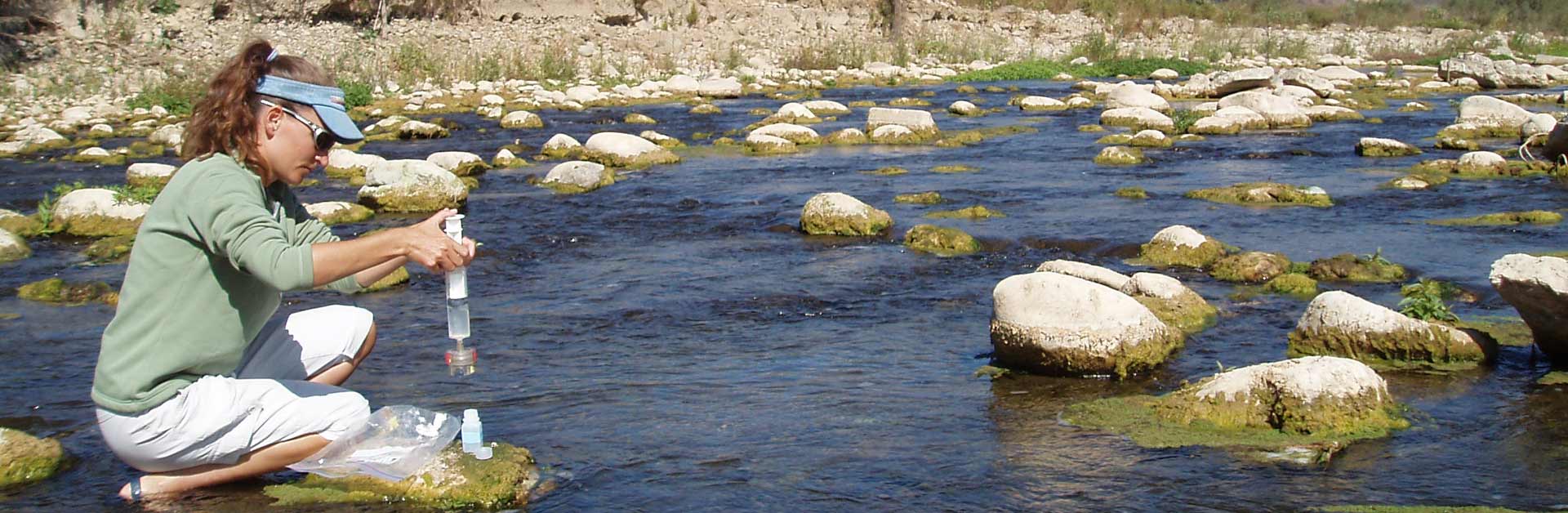 Volunteers doing field work collecting water samples in the Ventura River.